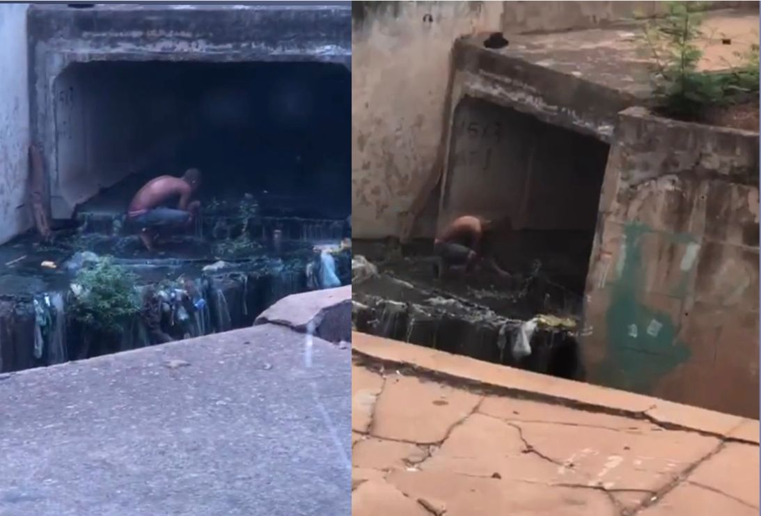 Homem toma banho em córrego de esgoto em Cuiabá